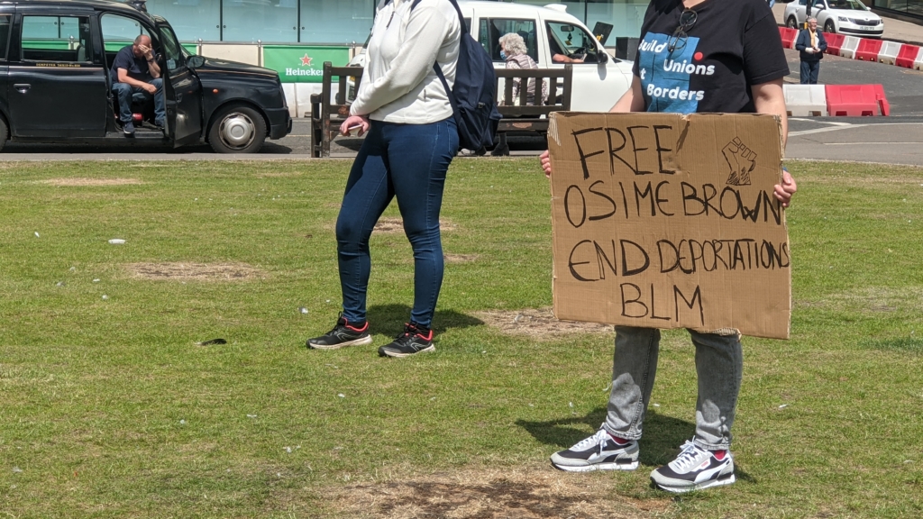 sign saying "free osime brown end deportations blm"